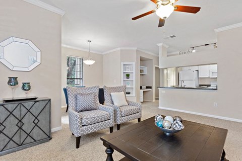 a living room with a table and chairs